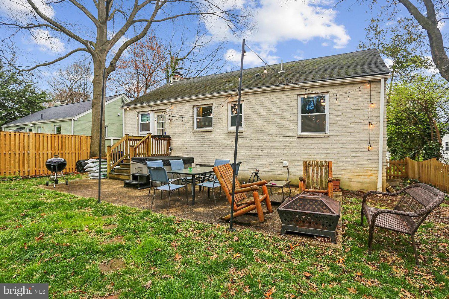 1611 Noyes Drive Silver Spring, MD 20910 - Photo 31 of 47 a view of a backyard with table and chairs potted plants and a large tree