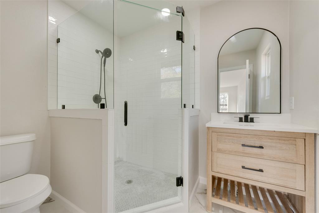 1614 Caddys Circle Garland, TX 75043 - Photo 13 of 13 a bathroom with a sink a toilet and shower