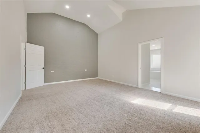 an empty room with closet and windows