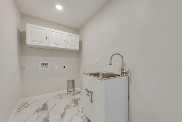 a close view of a sink and cabinets