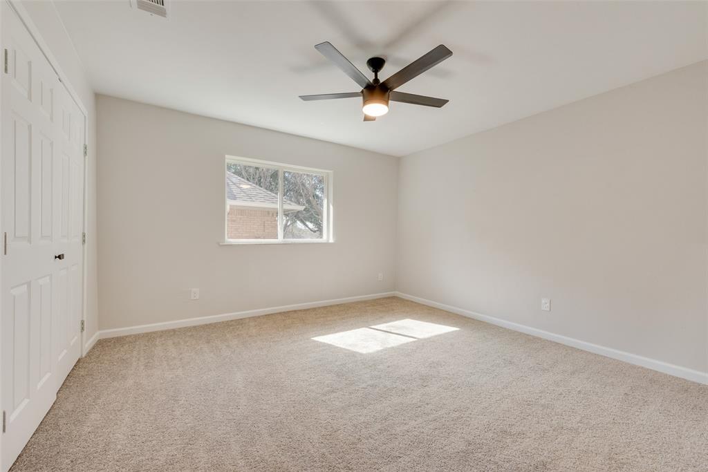 1614 Caddys Circle Garland, TX 75043 - Photo 9 of 13 an empty room with a window and a fan