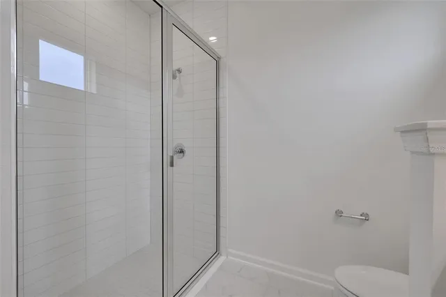 a bathroom with a shower and toilet