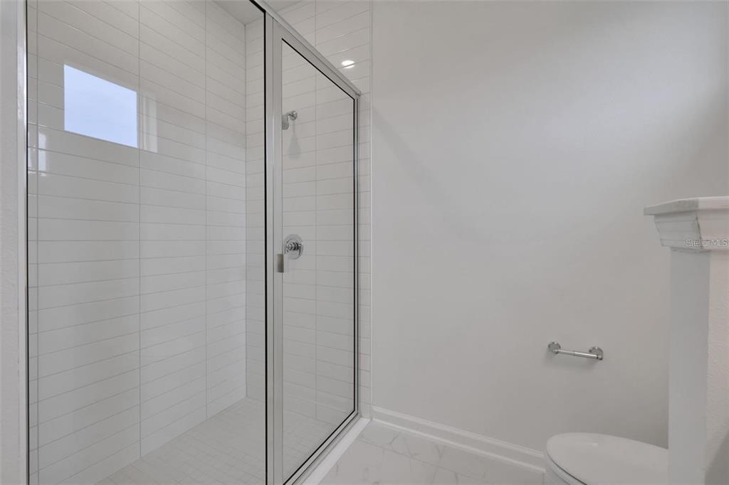 231 Misty Harbor Trace Palm Coast, FL 32137 - Photo 11 of 16 a bathroom with a shower and toilet
