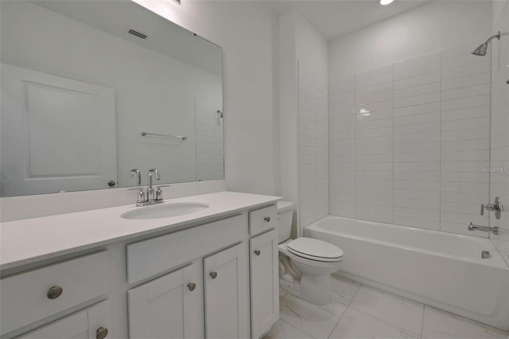 231 Misty Harbor Trace Palm Coast, FL 32137 - Photo 12 of 16 a bathroom with a sink a toilet and a bathtub