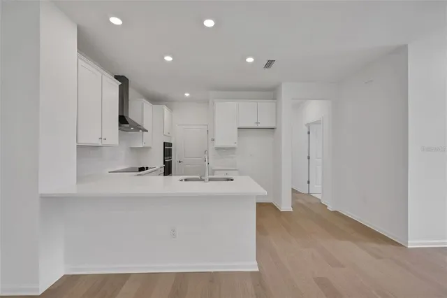a view of kitchen with white cabinets