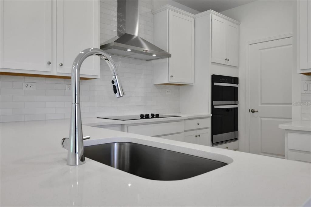 231 Misty Harbor Trace Palm Coast, FL 32137 - Photo 4 of 16 a kitchen with stainless steel appliances granite countertop a sink stove and refrigerator