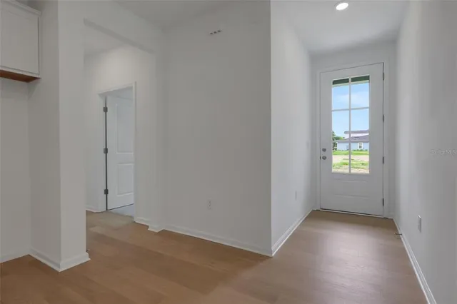 an empty room with windows and closet