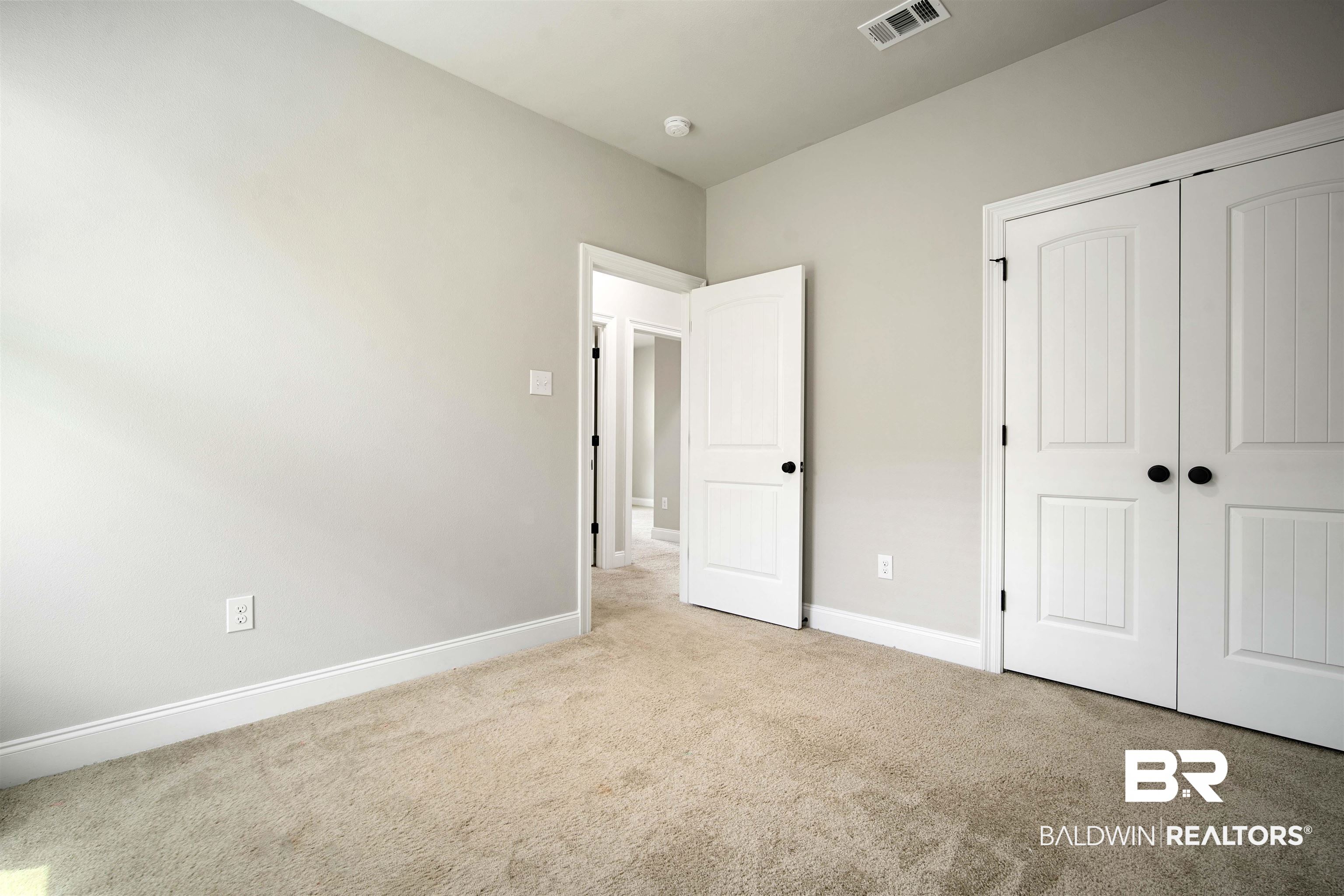 9924 Dunleith Loop Daphne, AL 36526 - Photo 20 of 33 Unfurnished bedroom with visible vents, carpet, baseboards, and a closet