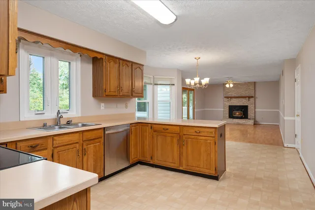 a large kitchen with stainless steel appliances granite countertop a sink and a stove