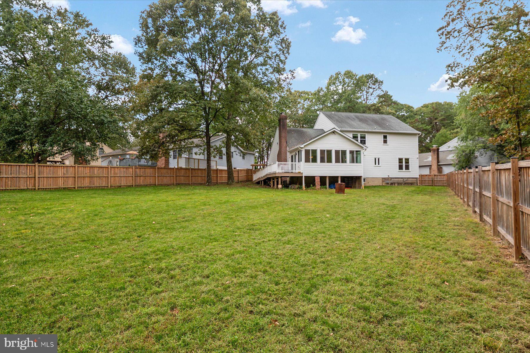 7907 Poplar Grove Road Severn, MD 21144 - Photo 38 of 38 a view of a house with a big yard and large trees