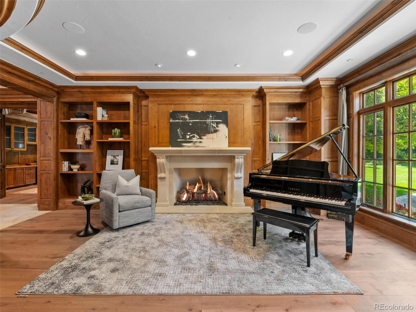 4 Haystack Row Cherry Hills Village, CO 80113 - Photo 13 of 31 a living room with furniture a piano and a fireplace