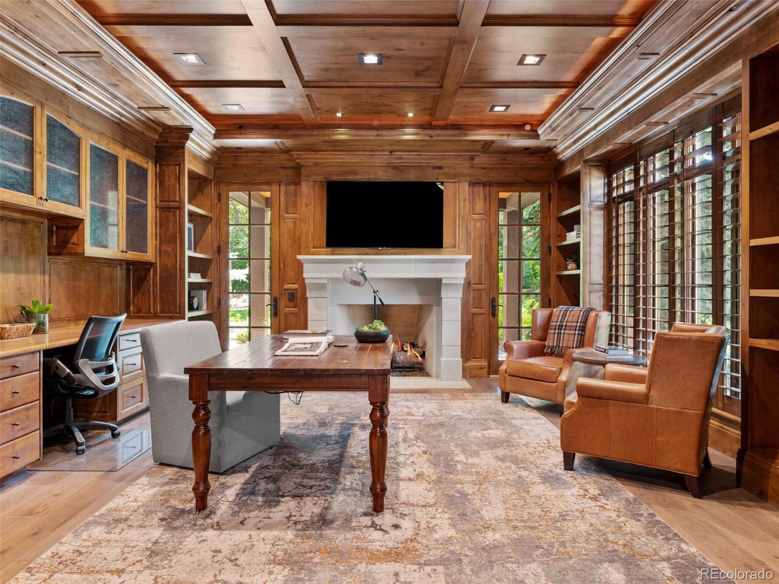 4 Haystack Row Cherry Hills Village, CO 80113 - Photo 18 of 31 a living room with furniture a fireplace and a flat screen tv