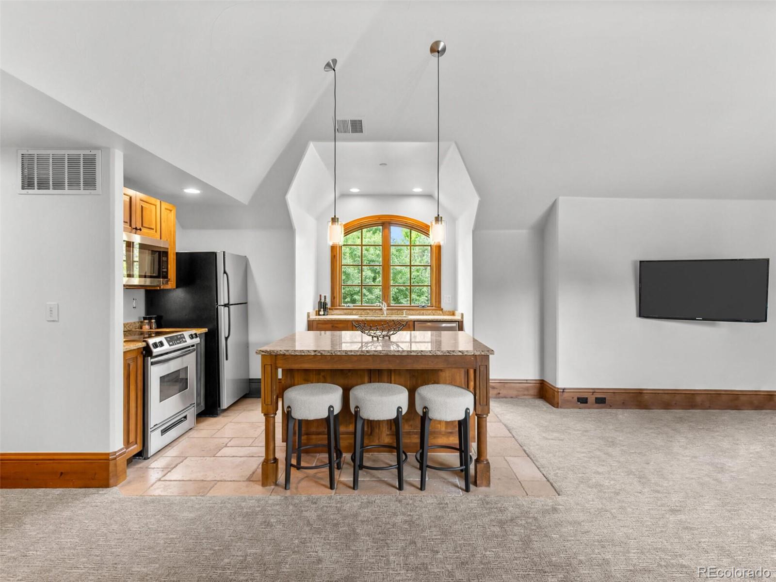 4 Haystack Row Cherry Hills Village, CO 80113 - Photo 26 of 31 a view of a kitchen area with furniture and stainless steel appliances