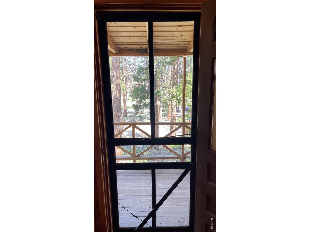 35 Robin Path Red Feather Lakes, CO 80545 - Photo 20 of 25 Rustic screen door opens to the covered front porch.