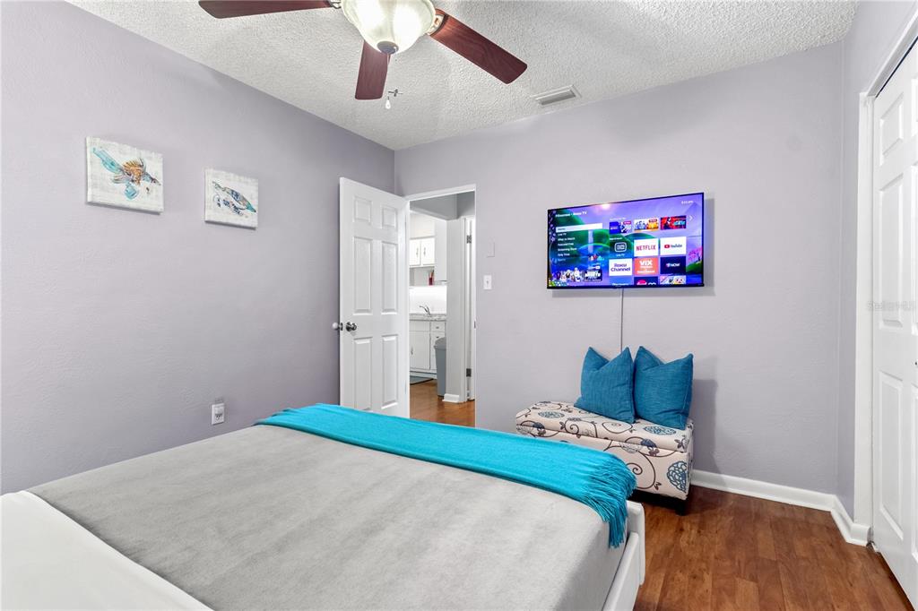 5596 100th Way North St. Petersburg, FL 33708 - Photo 9 of 67 a bedroom with a bed and a painting on the wall