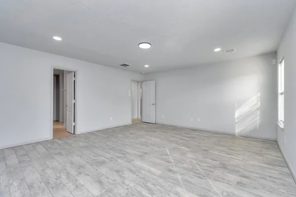 an empty room with windows and closet