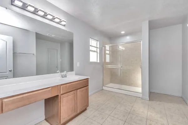a spacious bathroom with a sink a mirror and a bathtub