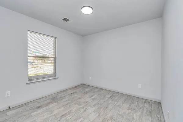 an empty room with closet area