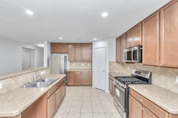 a spacious bathroom with a sink a mirror and a bath tub