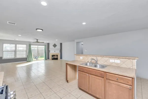 a view of a kitchen with furniture and refrigerator