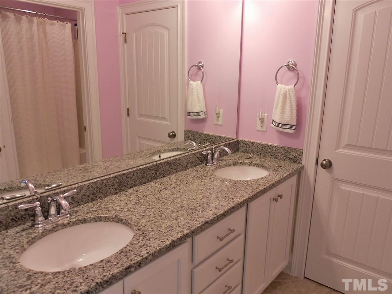 776 Fallon Grove Way Raleigh, NC 27608 - Photo 11 of 22 ...has two sinks in the granite counter top; the commode and shower are in a separate adjoining room (the shower curtain can be seen in the mirror)