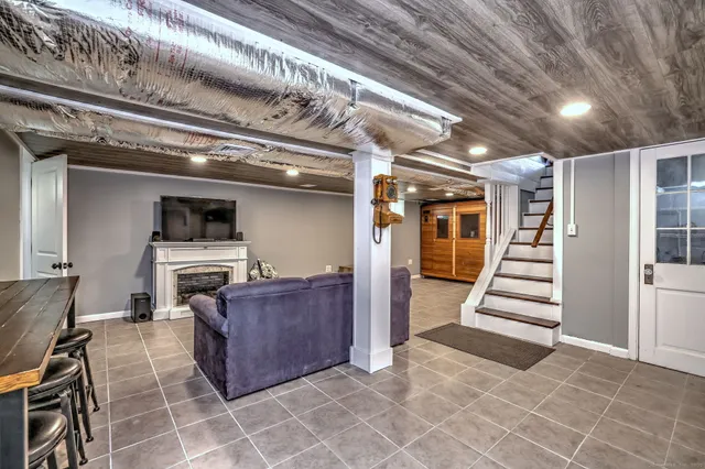 a living room with furniture a dining table and chairs