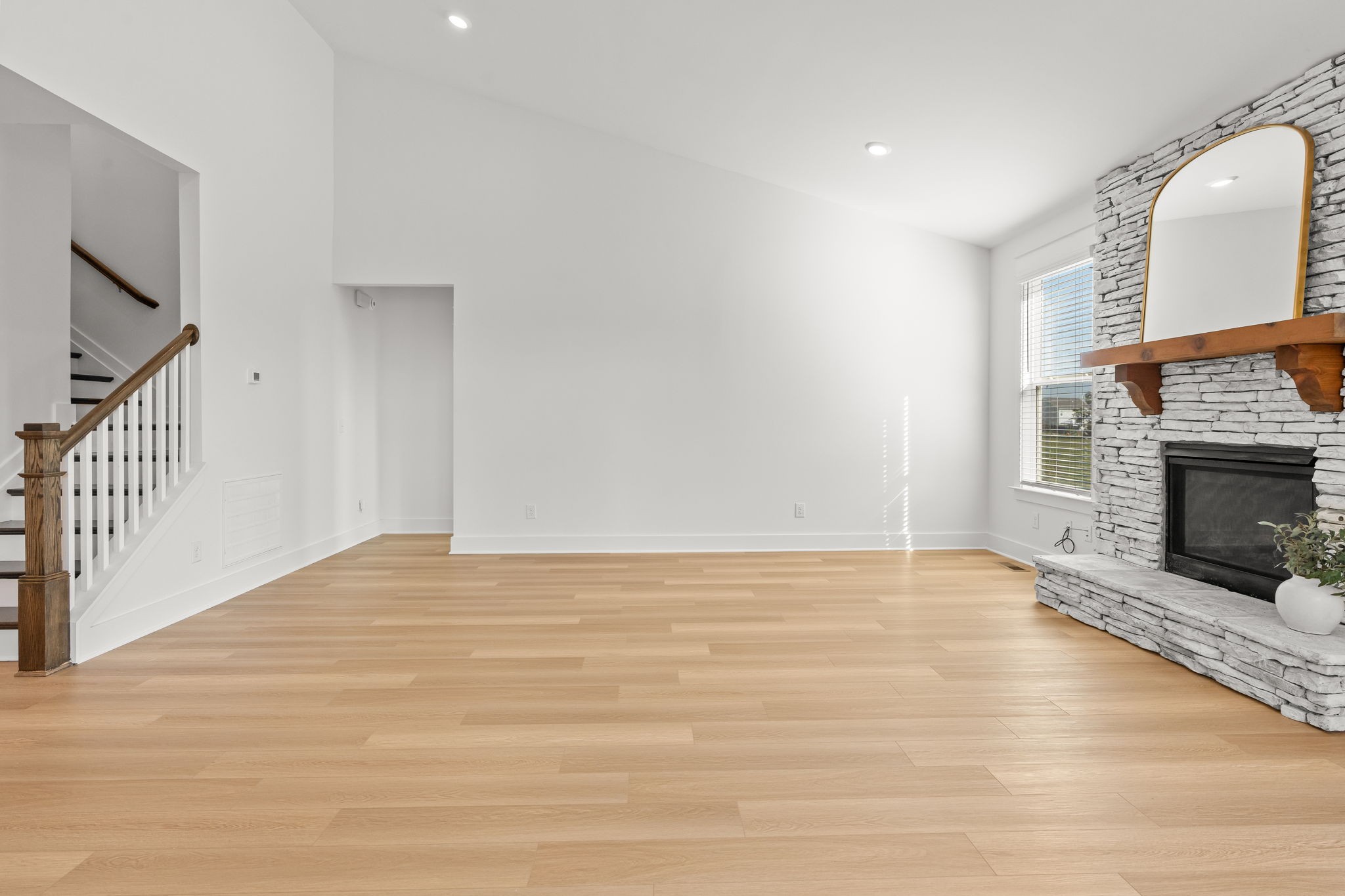 1257 Cotillion Drive Murfreesboro, TN 37128 - Photo 7 of 34 a view of an empty room with wooden floor fireplace and a window