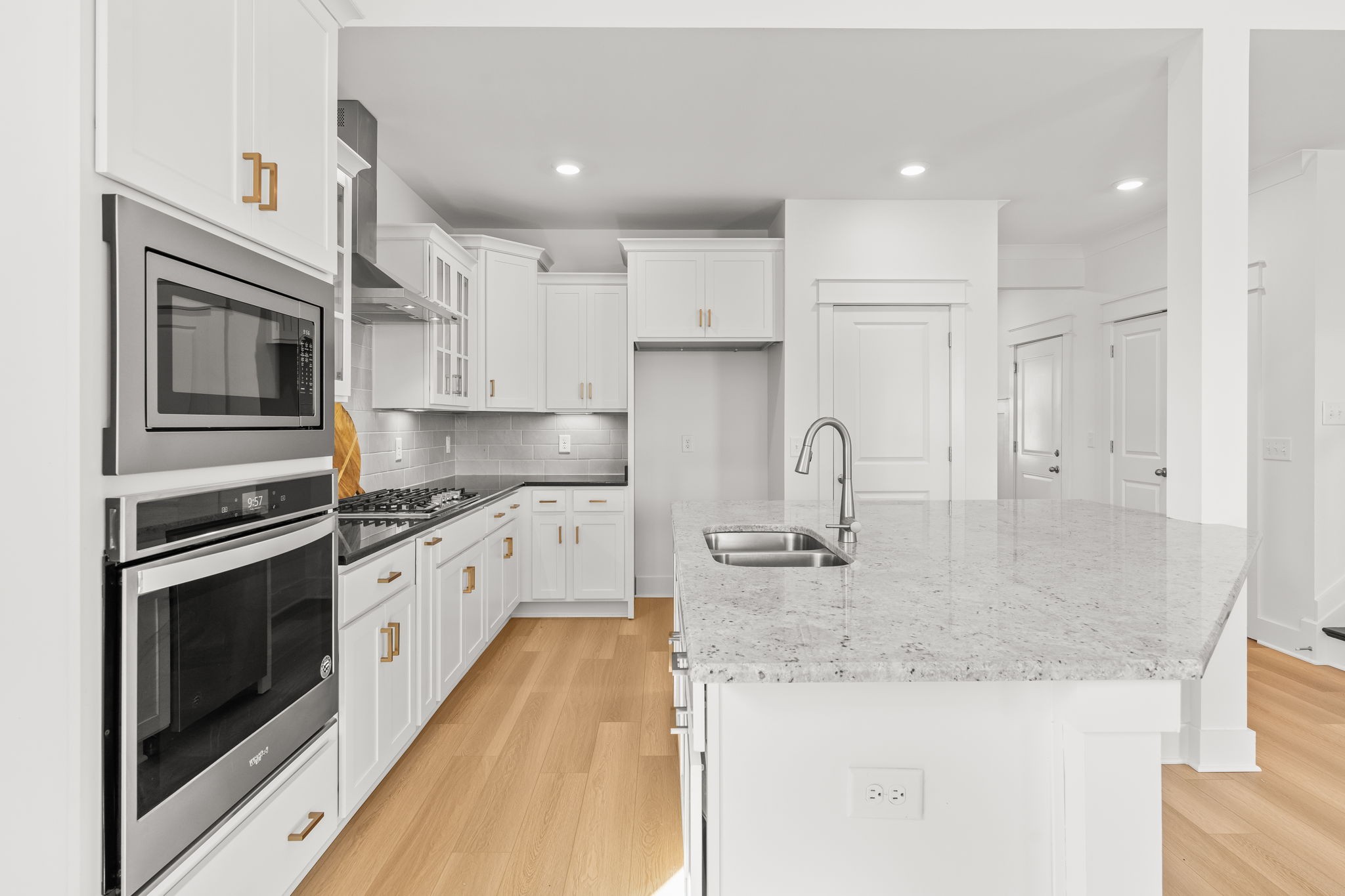 1257 Cotillion Drive Murfreesboro, TN 37128 - Photo 8 of 34 a large kitchen with granite countertop a stove top oven a sink a counter space and cabinets