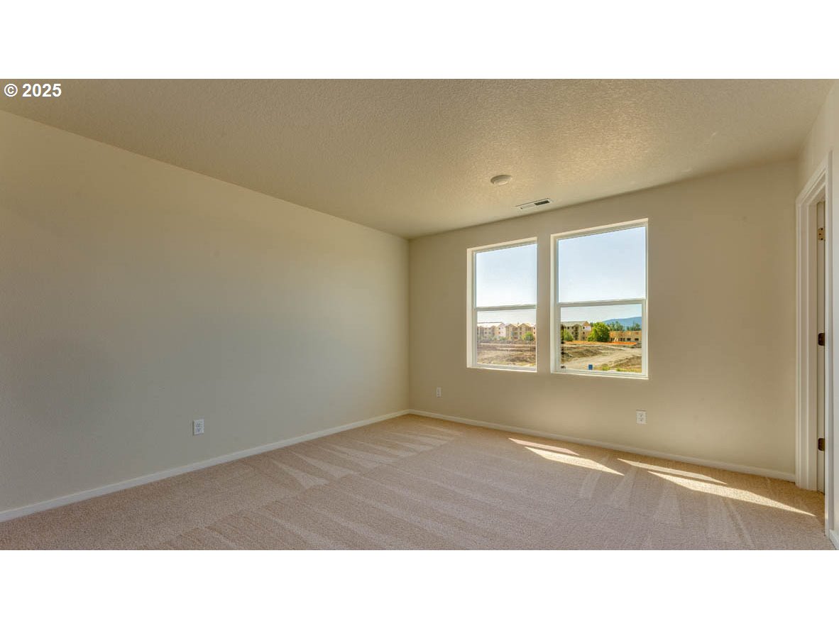 2960 U Street Springfield, OR 97477 - Photo 11 of 24 a open hall with a floor to ceiling window and a wooden floor