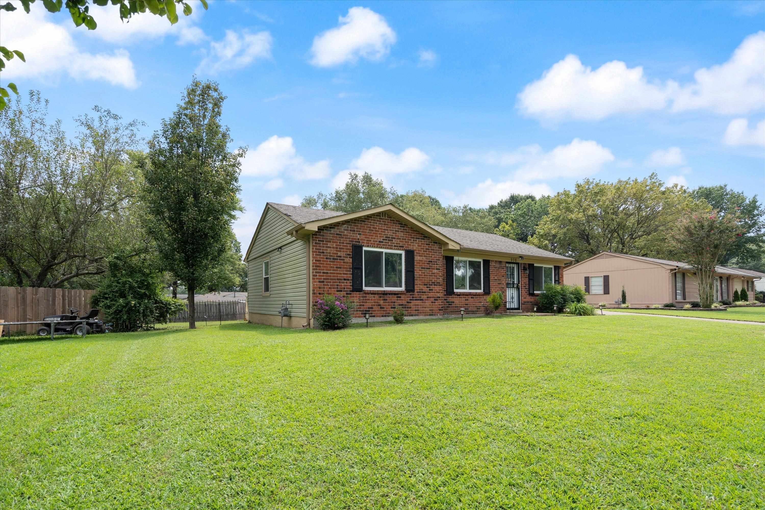 970 Poplar Leaf Road Collierville, TN 38017 - Photo 3 of 20 a big house with a big yard and large trees