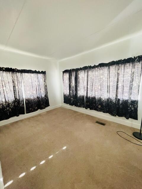 80870 Highway 111 Indio, CA 92201 - Photo 9 of 16 an empty room with a large window and tree s
