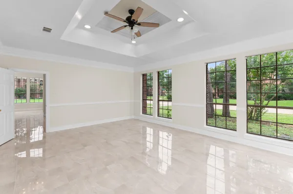 a view of a livingroom with a ceiling fan and window