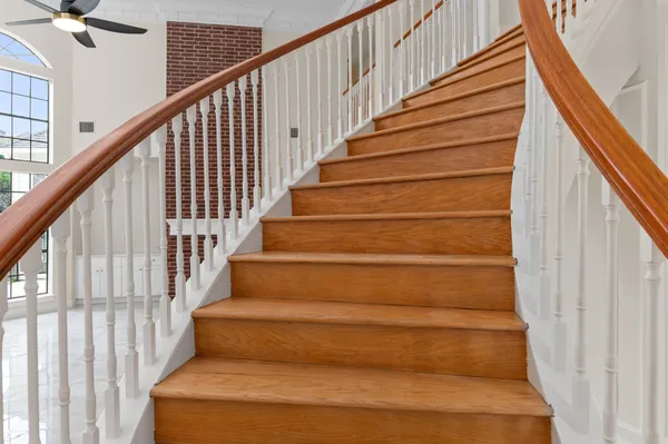 a view of an empty room with a window and a kitchen area