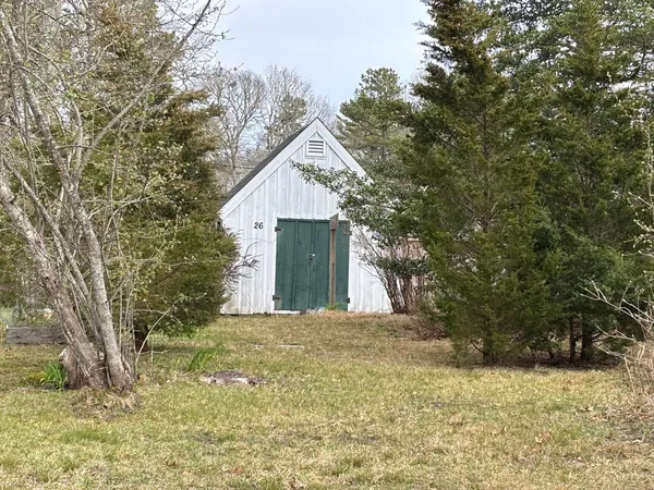 a view of a wooden house with a yard