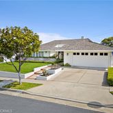 a house with green field in front of it