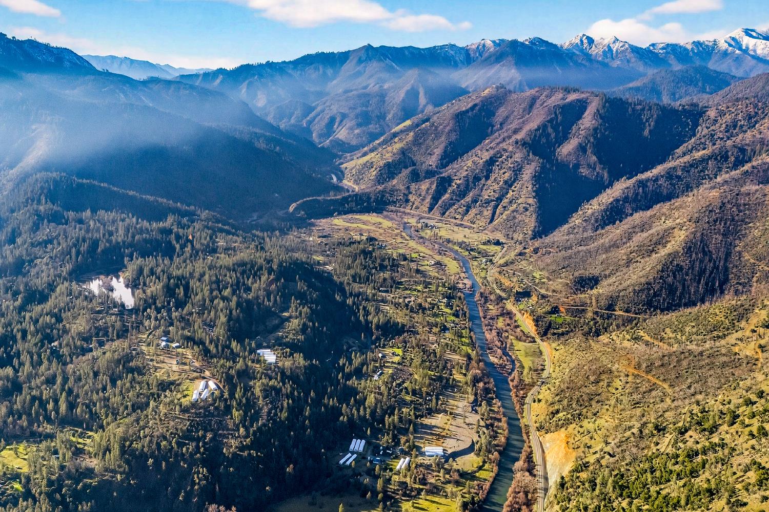 a view of a house with a mountain and trees