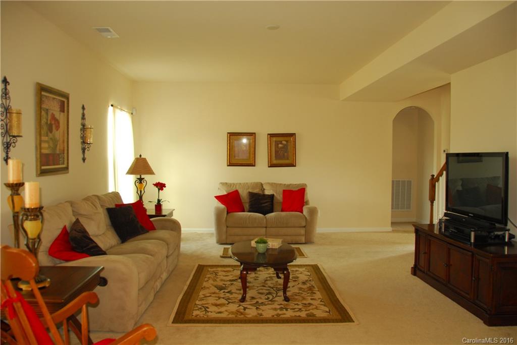 2181 Galloway Lane Southwest Concord, NC 28025 - Photo 4 of 11 a living room with furniture and a flat screen tv