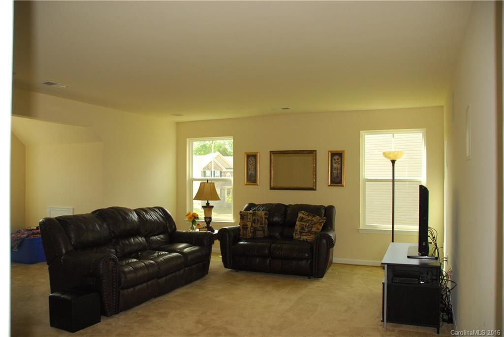 2181 Galloway Lane Southwest Concord, NC 28025 - Photo 7 of 11 a living room with furniture and a flat screen tv