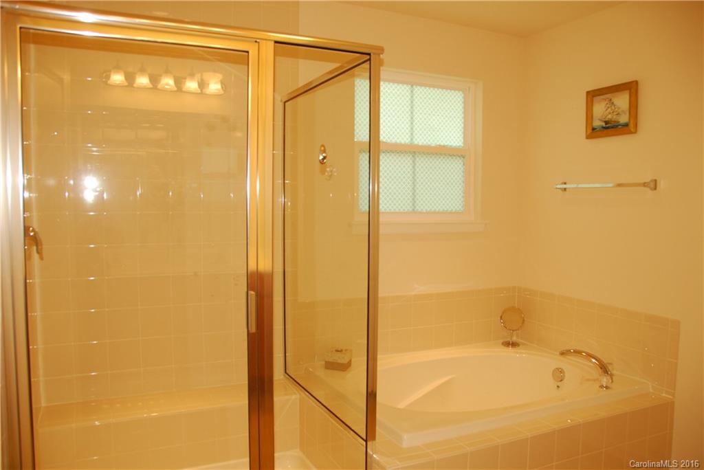 2181 Galloway Lane Southwest Concord, NC 28025 - Photo 9 of 11 a bathroom with a glass shower door