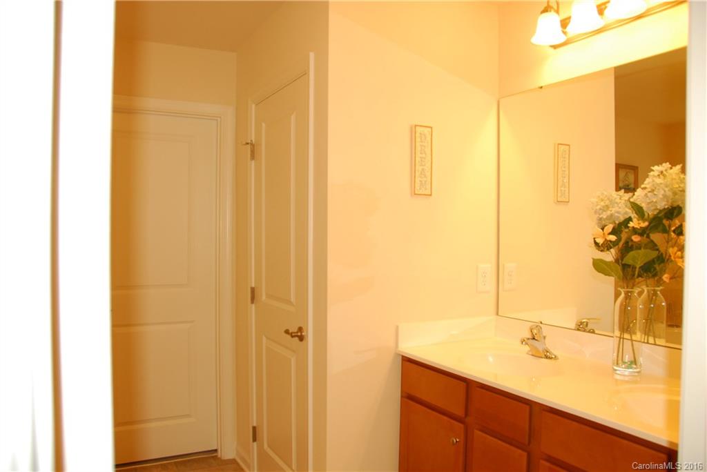 2181 Galloway Lane Southwest Concord, NC 28025 - Photo 10 of 11 a bathroom with a granite countertop sink and a mirror
