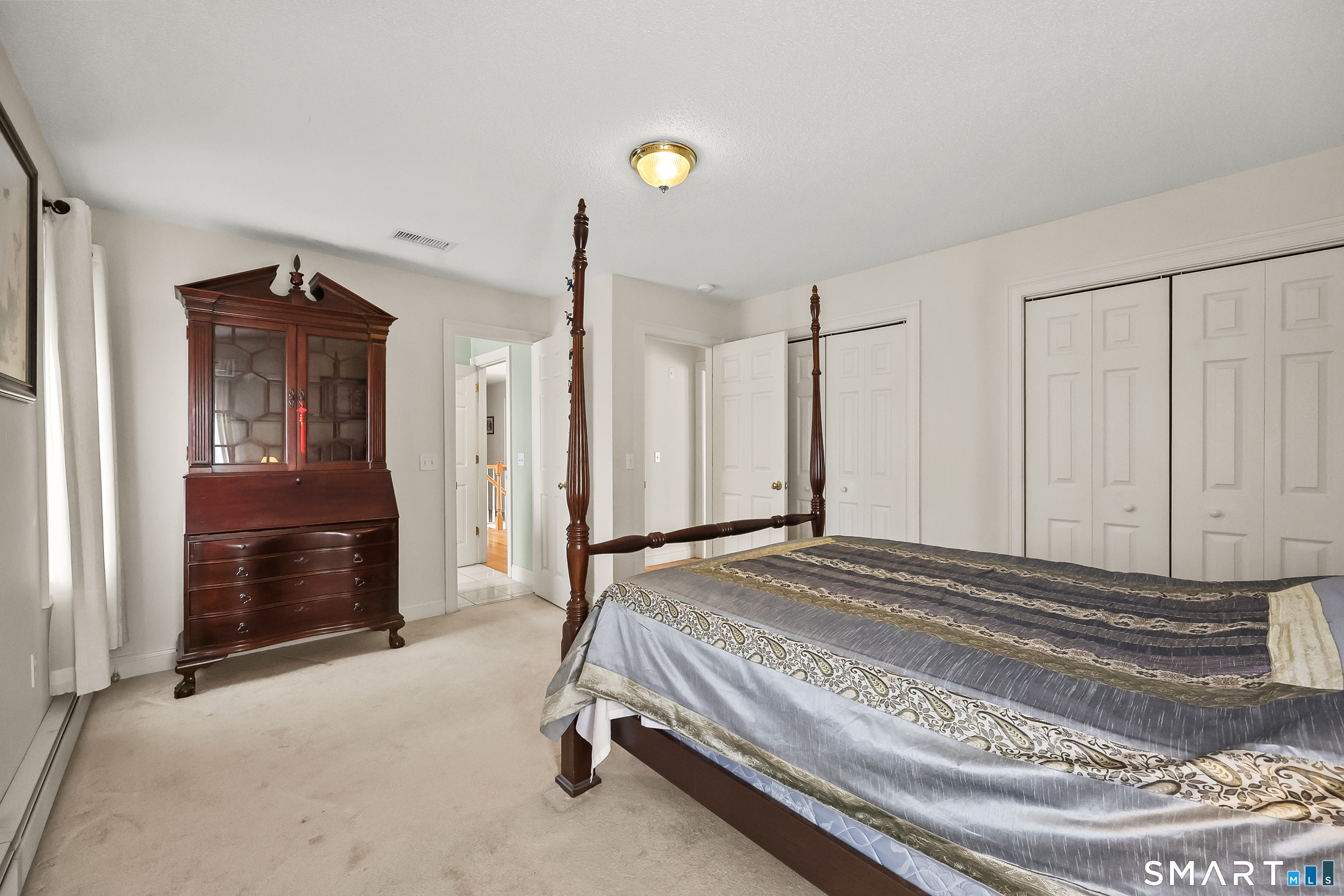 87 Wanda Lane Middletown, CT 06457 - Photo 23 of 39 a bedroom with a bed and a dresser with mirror