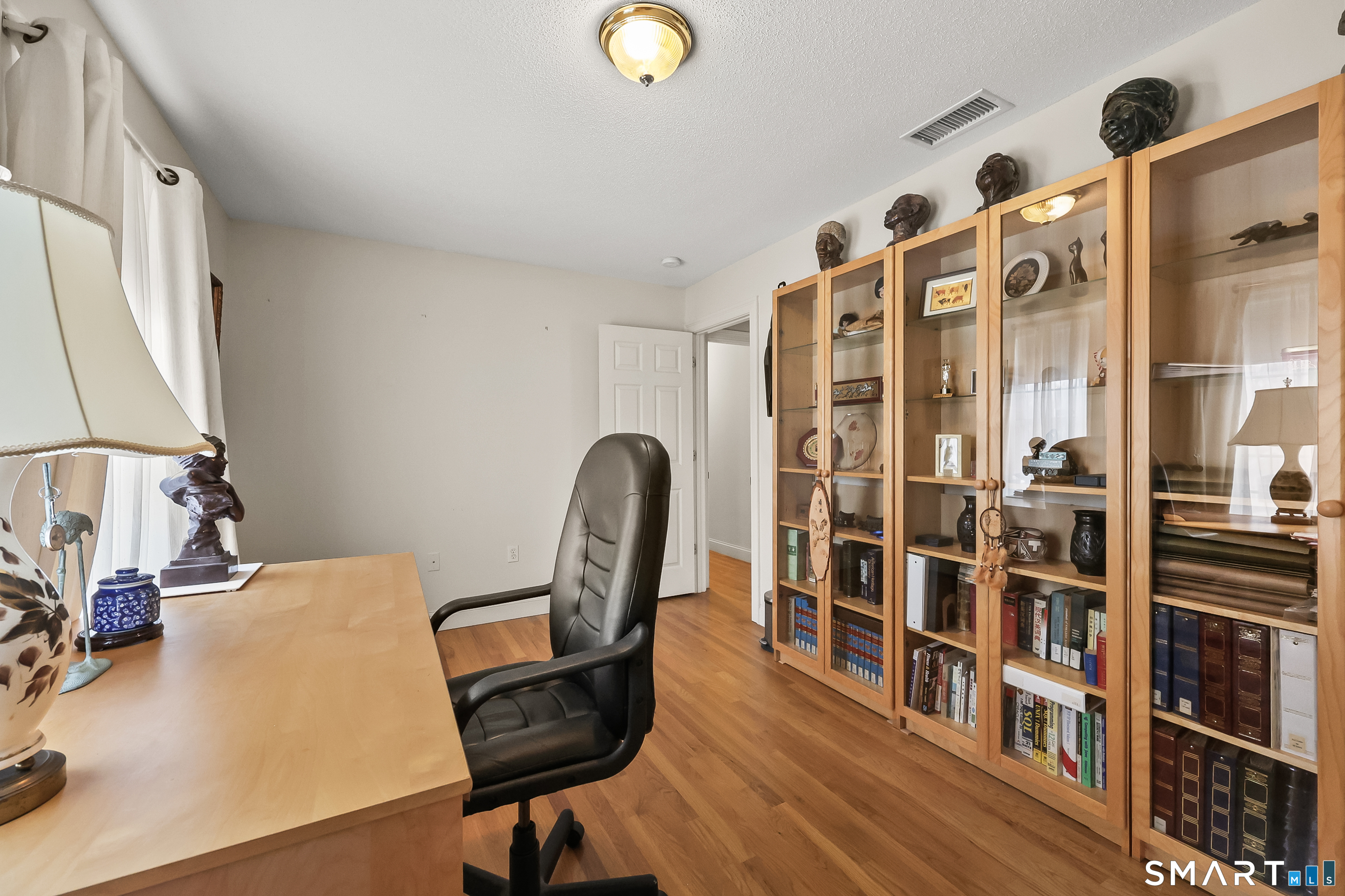 87 Wanda Lane Middletown, CT 06457 - Photo 28 of 39 a view of a workspace with furniture and wooden floor