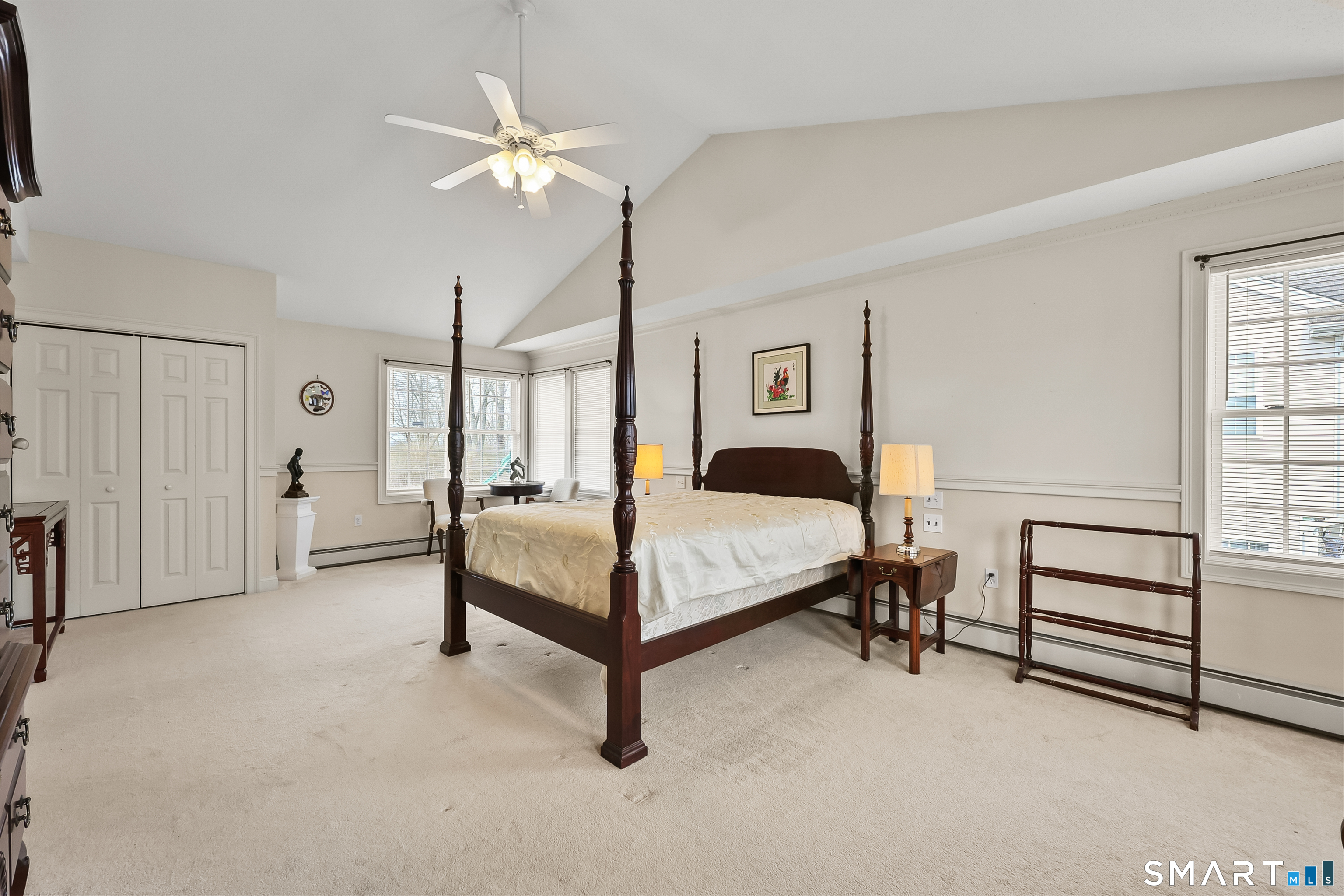 87 Wanda Lane Middletown, CT 06457 - Photo 33 of 39 a bedroom with a bed and a chandelier