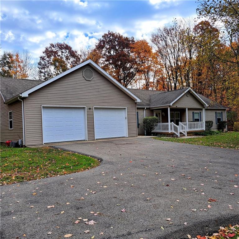 7224 Country Club Road Butler, PA 16001 - Photo 1 of 43 a front view of a house with a yard and garage