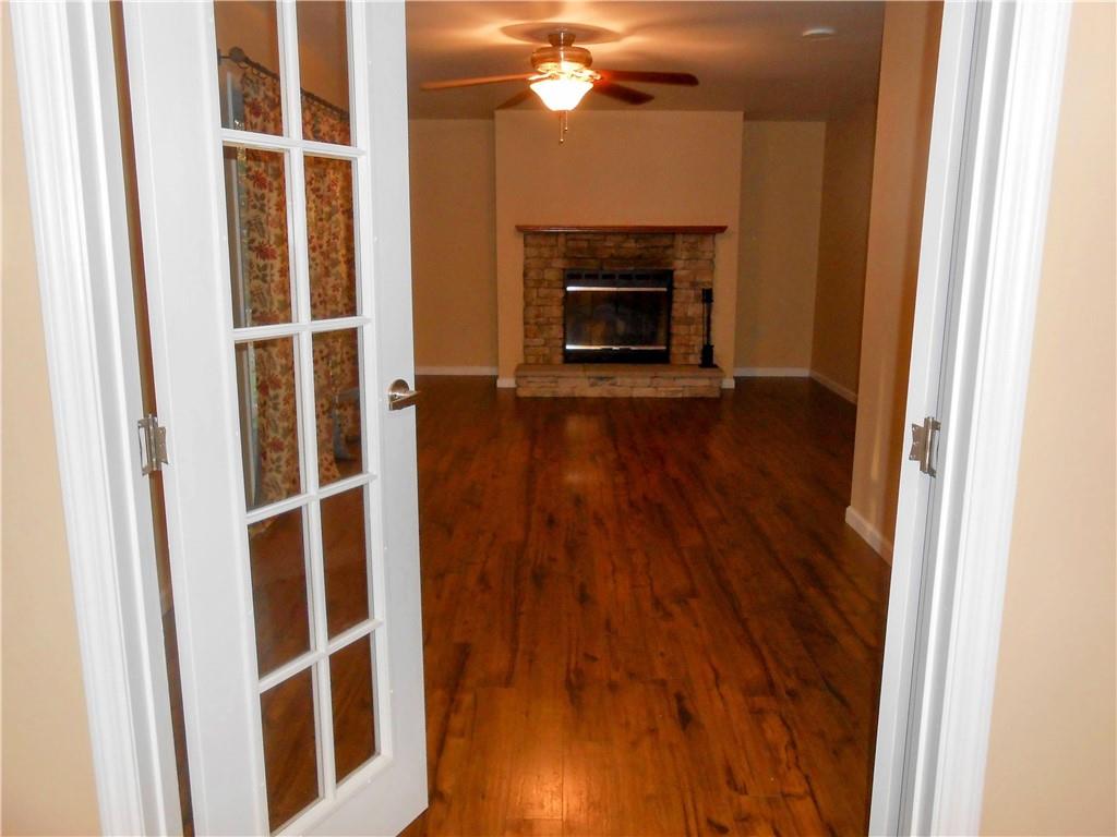 7224 Country Club Road Butler, PA 16001 - Photo 11 of 43 a view of a livingroom with wooden floor and a fireplace