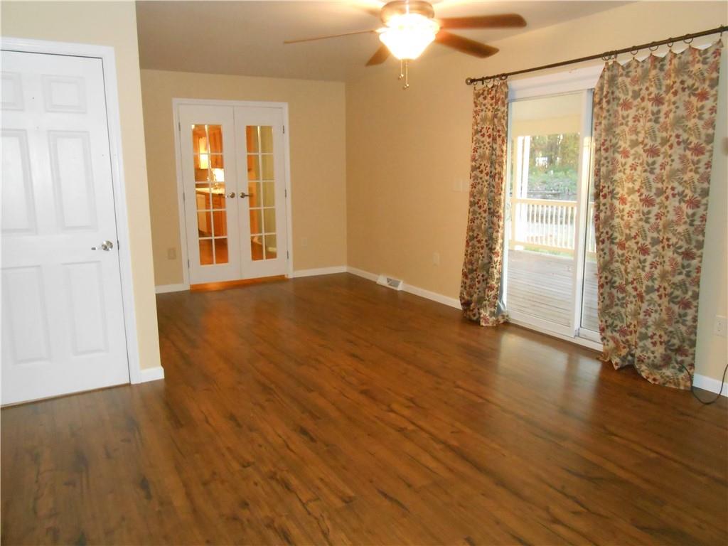 7224 Country Club Road Butler, PA 16001 - Photo 12 of 43 a view of an empty room with wooden floor and a window