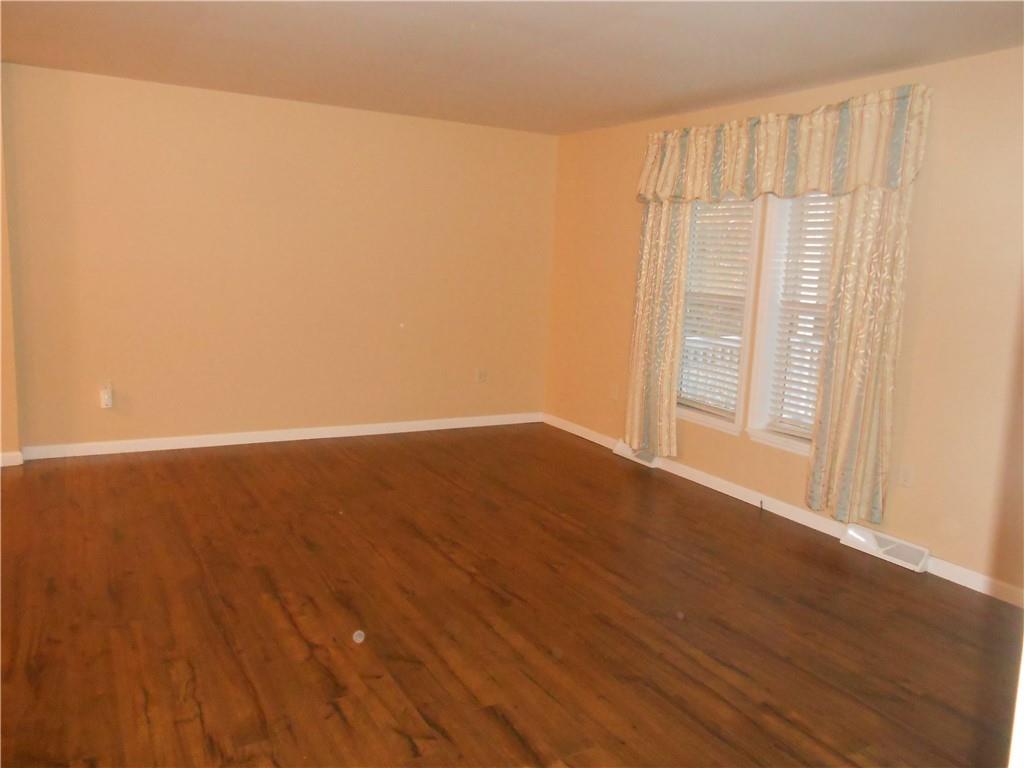 7224 Country Club Road Butler, PA 16001 - Photo 14 of 43 a view of an empty room with wooden floor and a window