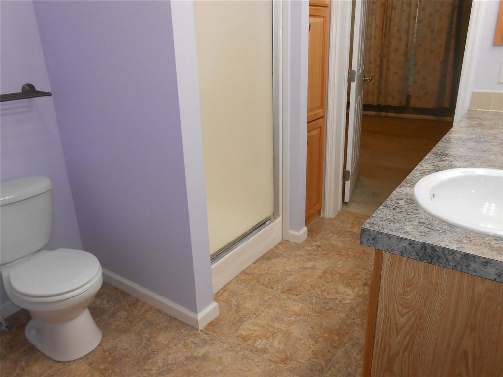 7224 Country Club Road Butler, PA 16001 - Photo 18 of 43 a bathroom with a granite countertop toilet and a sink