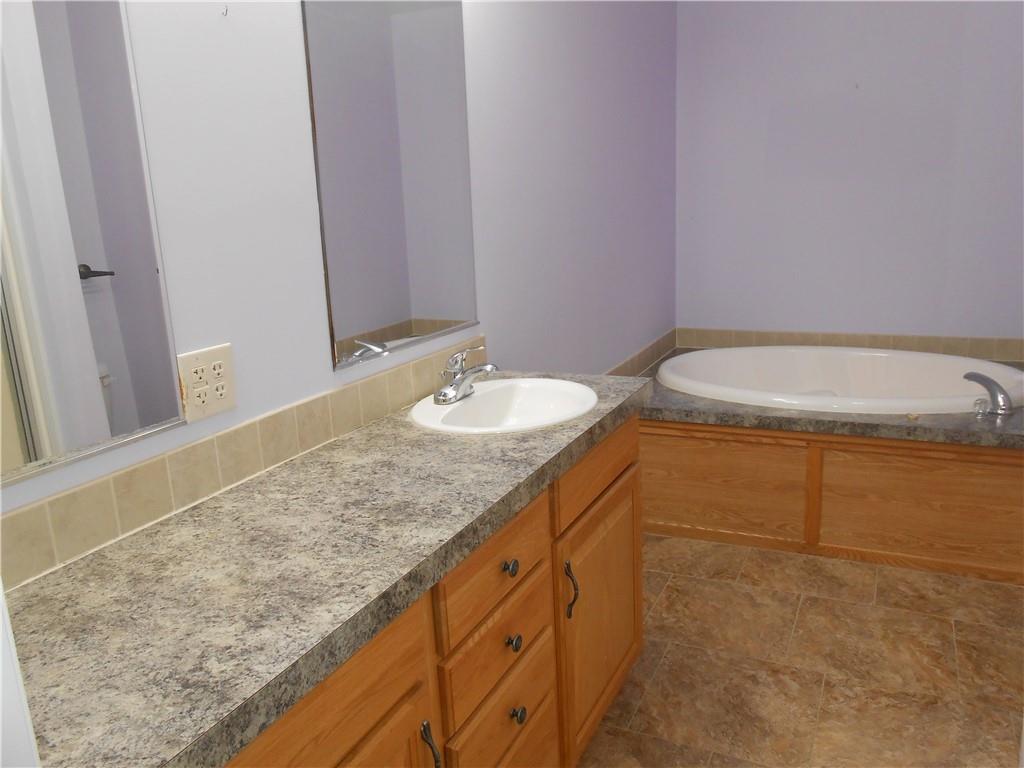 7224 Country Club Road Butler, PA 16001 - Photo 19 of 43 a bathroom with a granite countertop sink and a mirror