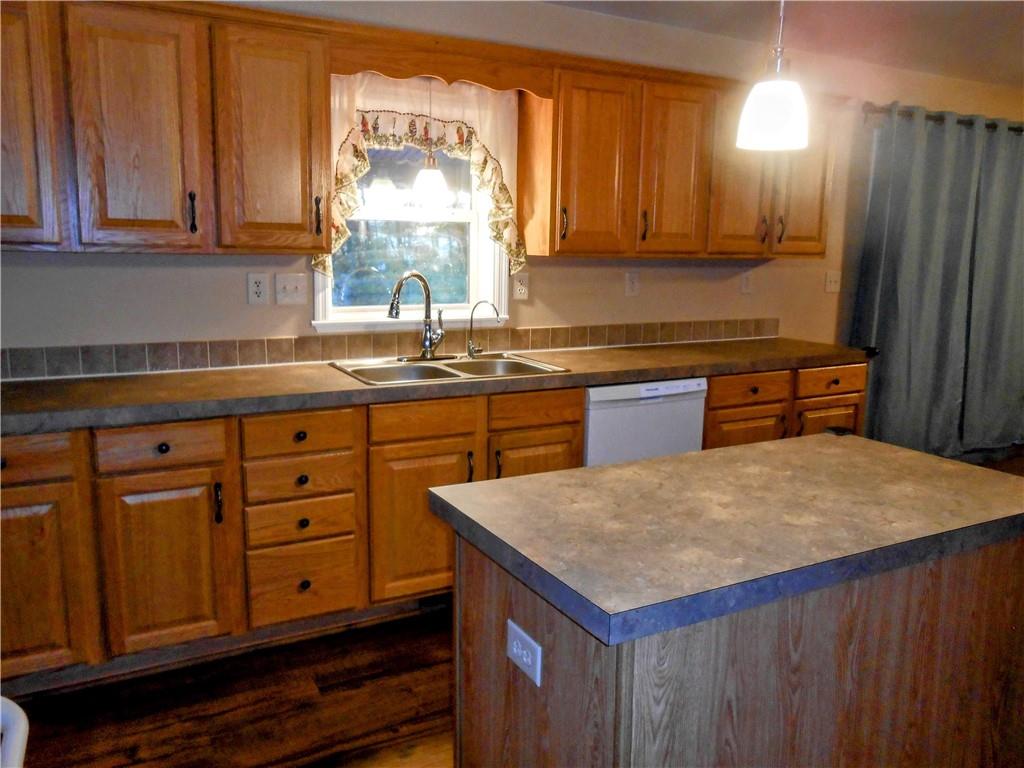 7224 Country Club Road Butler, PA 16001 - Photo 3 of 43 a kitchen with granite countertop a sink dishwasher stove and cabinets